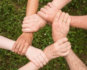 Hands connected in a circle 